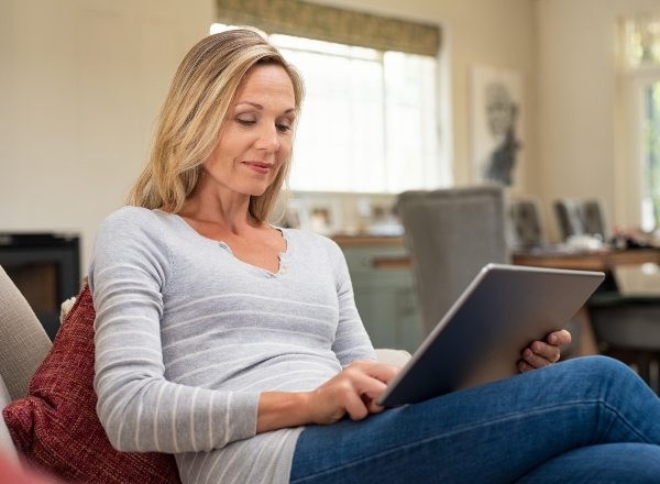Woman scrolling on a tablet Woman scrolling on a tablet
