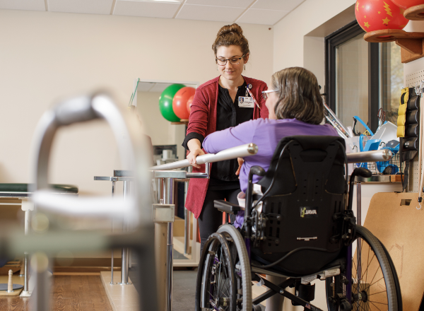 Therapist helping a patient in wheelchair